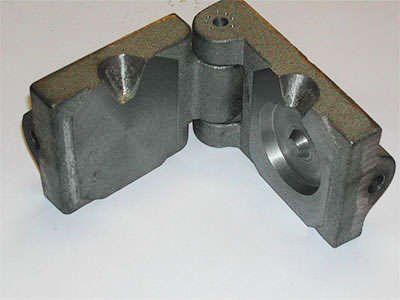 A close up of a metal object on a white surface.