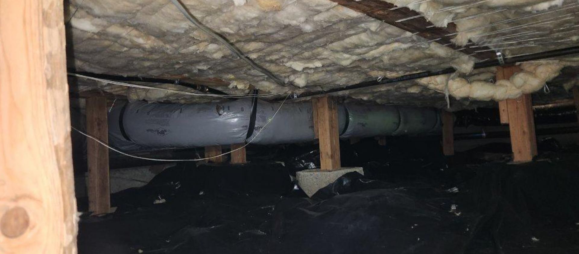 crawl space with fiberglass insulation