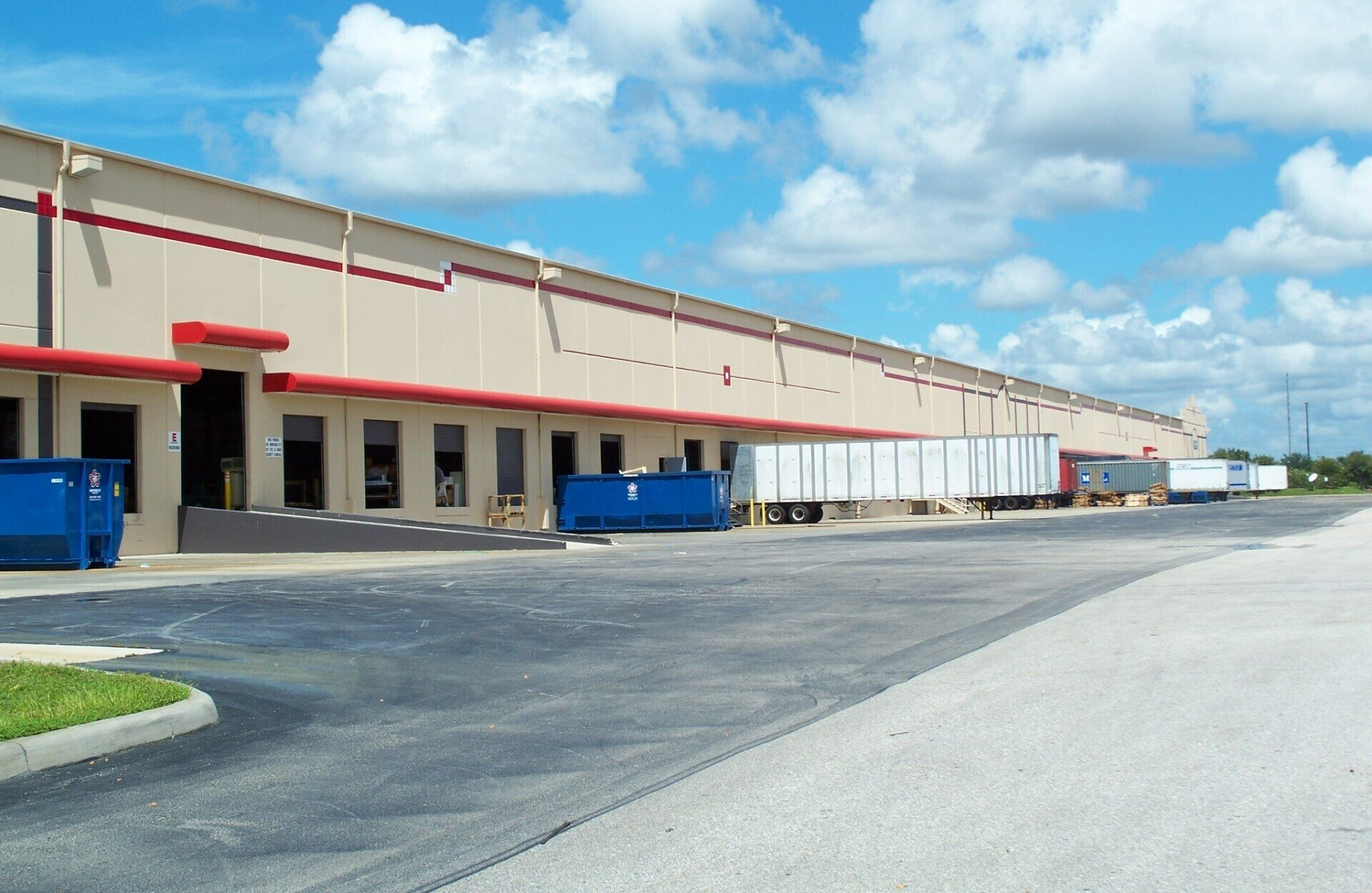A large building with a lot of trucks parked in front of it