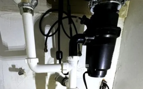 GTZ Plumbing Service LLC - A garbage disposal is sitting under a sink in a bathroom.