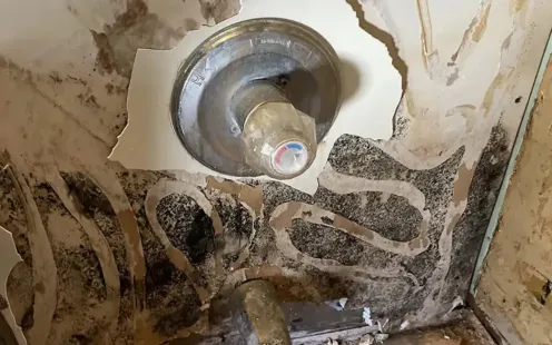 Healthy Crawlspace North Carolina | a  crawl space with a lot of pipes coming out of it