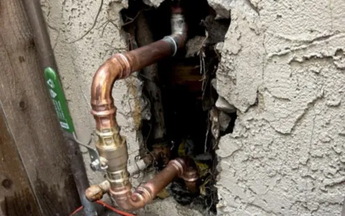 Healthy Crawlspace North Carolina | a man wearing a hard hat is working under a crawl space