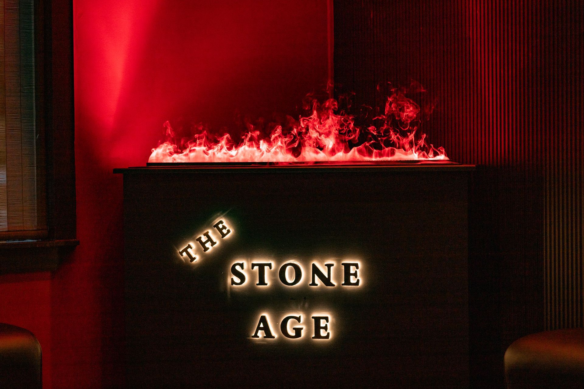 A dimly lit bar sign that reads 