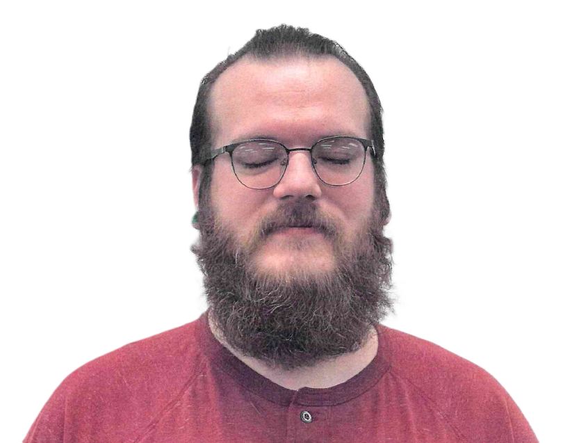 Man with a beard and glasses, eyes closed, wearing a red shirt, against a white background.