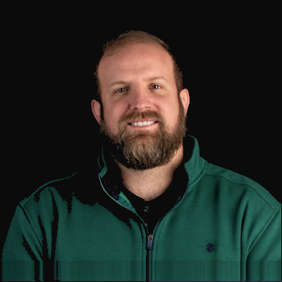 A man with a beard smiling for the camera