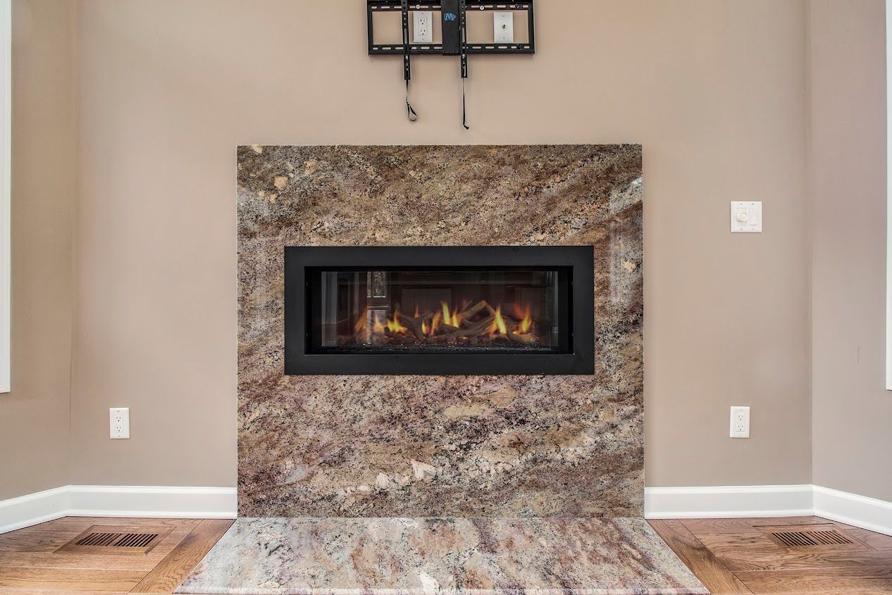 Modern living room fireplace with stone surround and beige walls