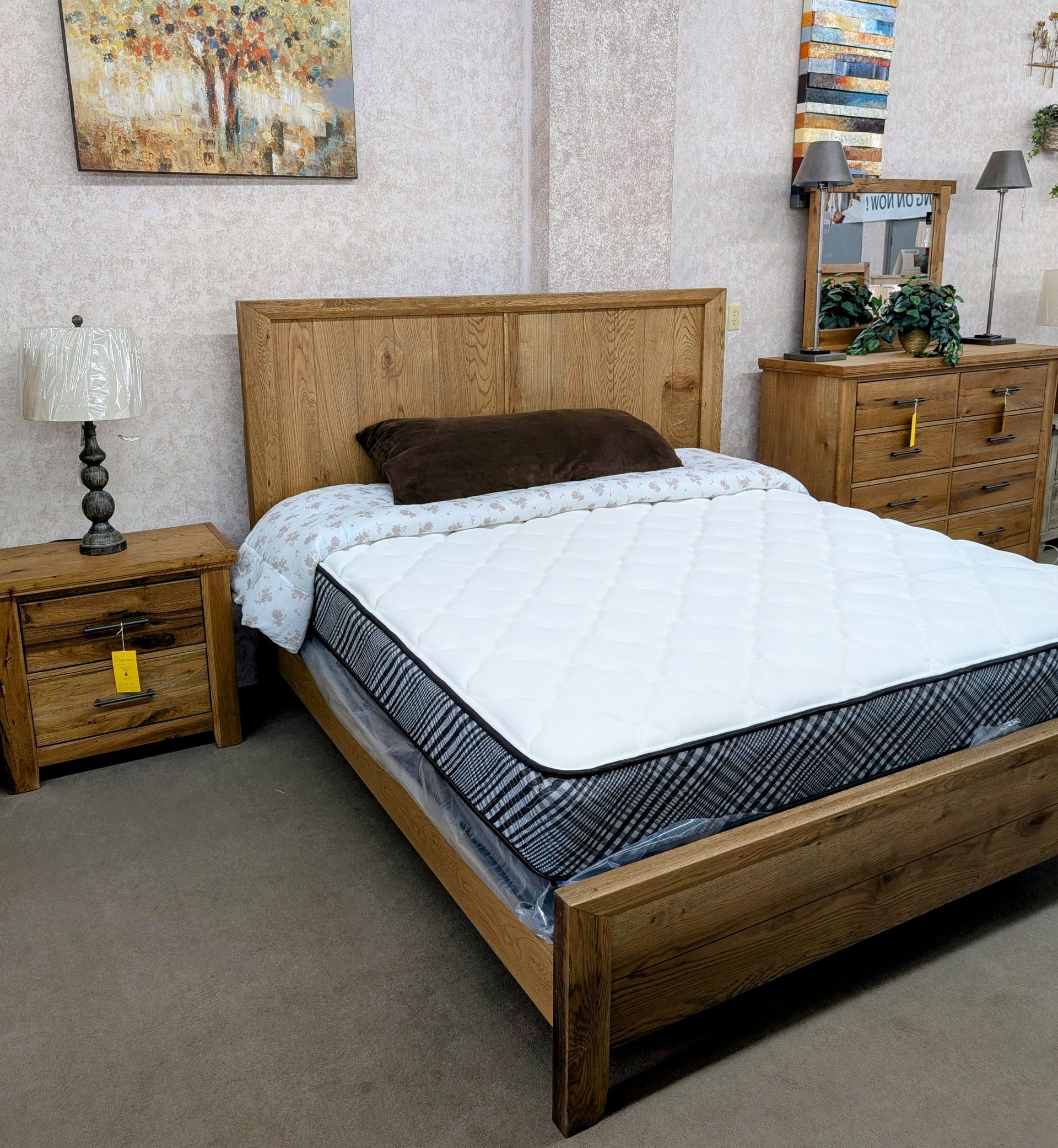 A bedroom with a wooden bed and a mattress