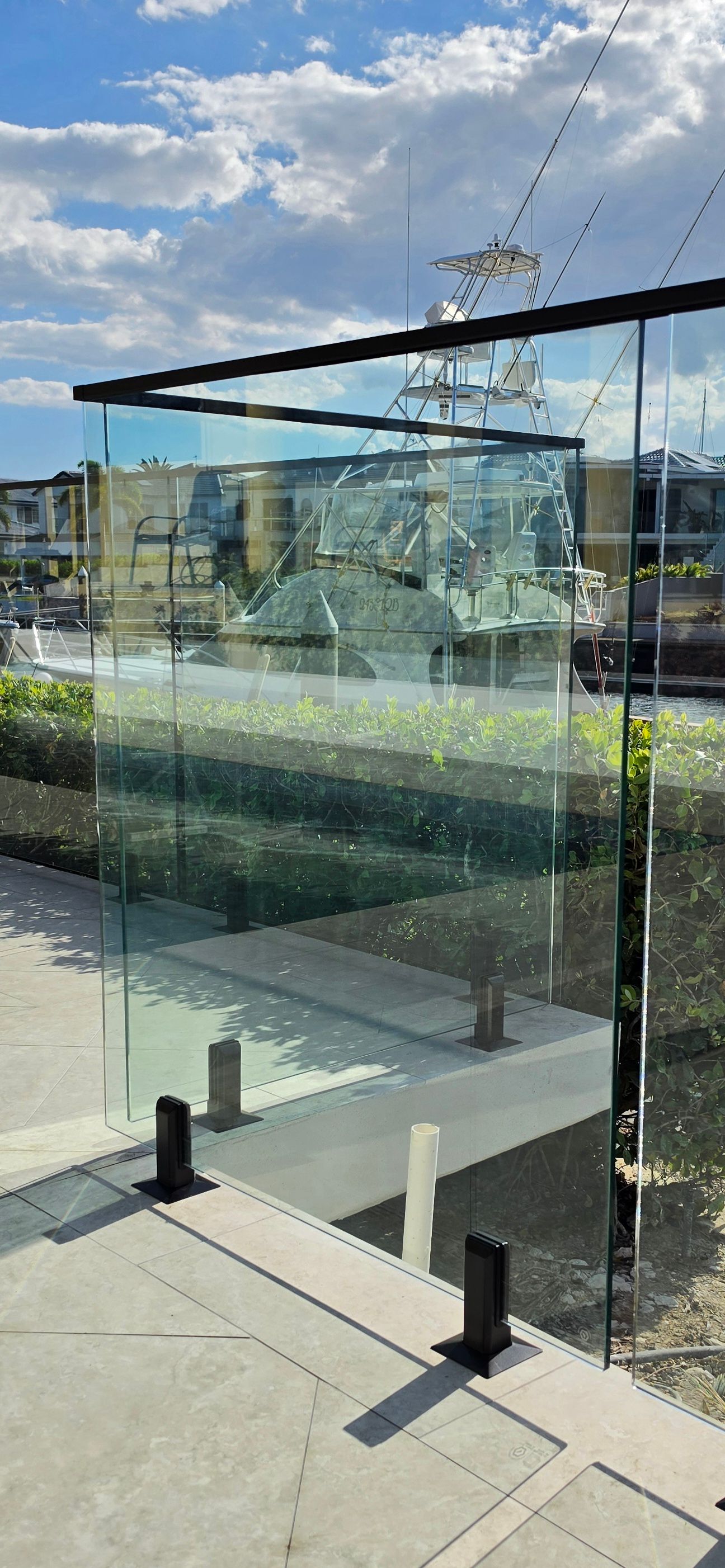 Glass-railed outdoor terrace with city skyline and blue sky beyond