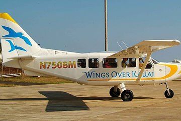 Small white-and-yellow airplane on runway with