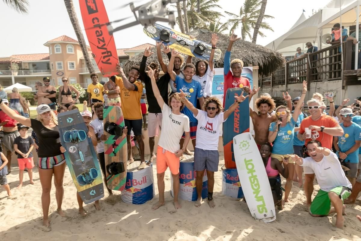 Group of skateboarders posing on a sunny beach with boards, cheering and smiling in cabarete sosua