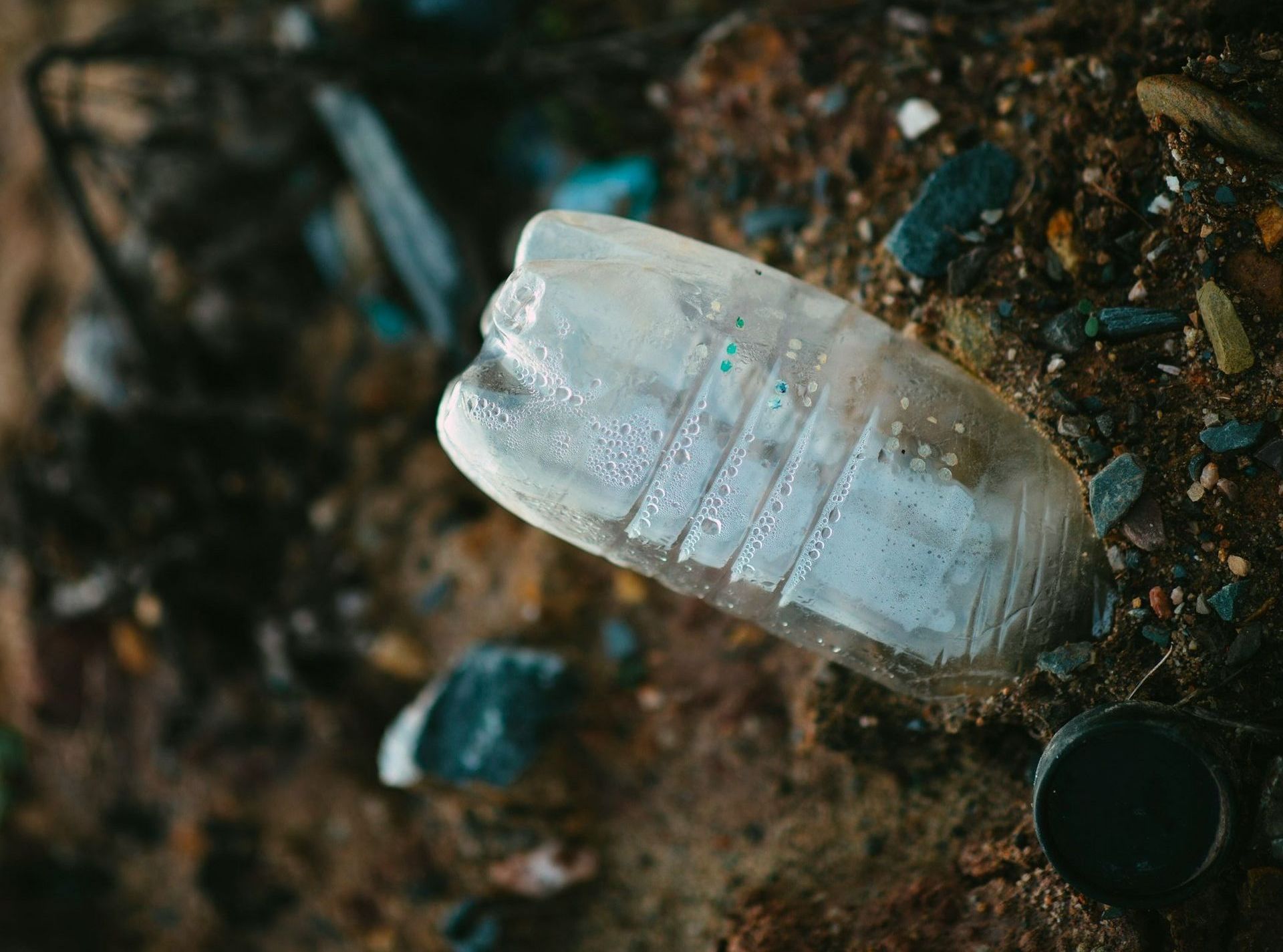 A plastic bottle is laying on the ground.