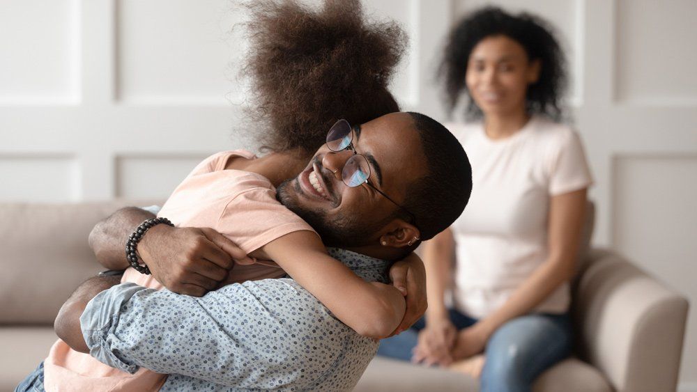 Father Hugging His Daughter — Covington, LA — Brittany V. Carter Attorney at Law L.L.C. Father Hugging His Daughter — Covington, LA — Brittany V. Carter Attorney at Law L.L.C.