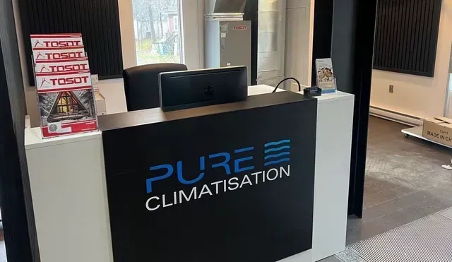 Un bureau d'accueil climatisé dans une pièce avec un ordinateur dessus.