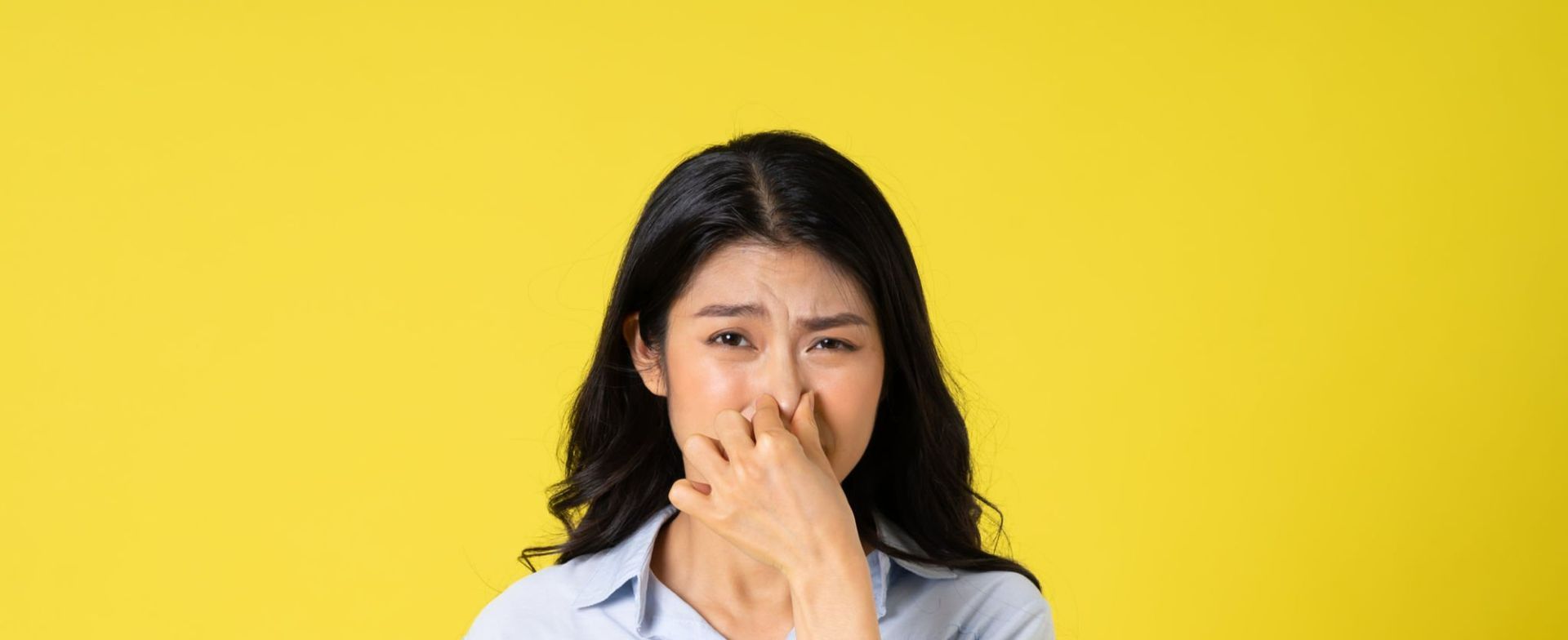 women plugging nose