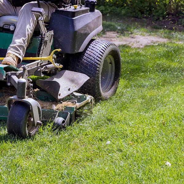 close up of someone on riding lawn mower