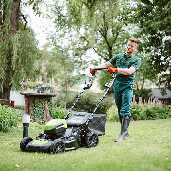 employee mowing lawn
