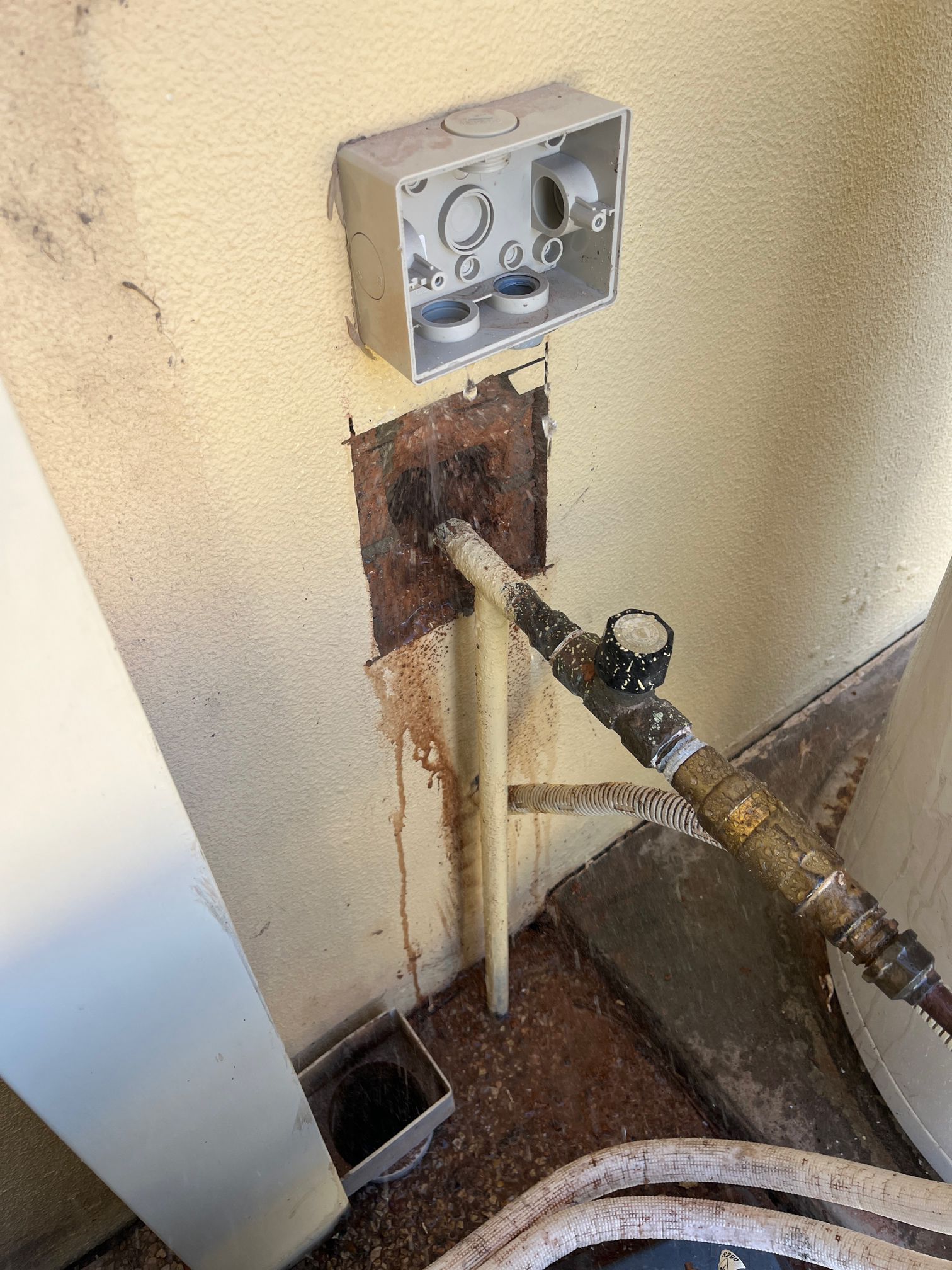 Rusty Wall-mounted Utility Hookups With Exposed Pipes — Huddo's Plumbing Service in Wallalong, NSW