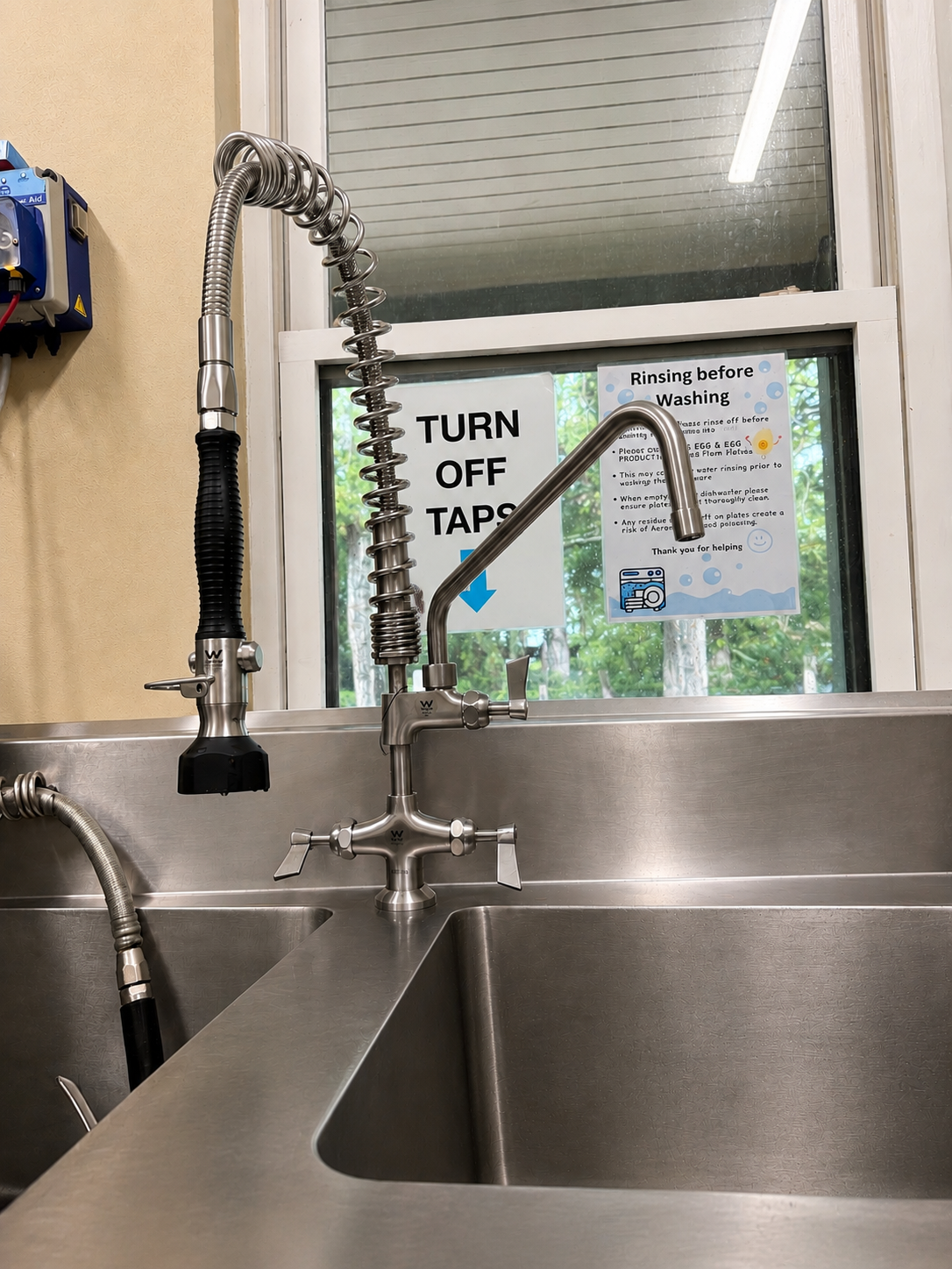 Stainless Steel Sink With Flexible Faucet In A Kitchen — Huddo's Plumbing Service in Wallalong, NSW