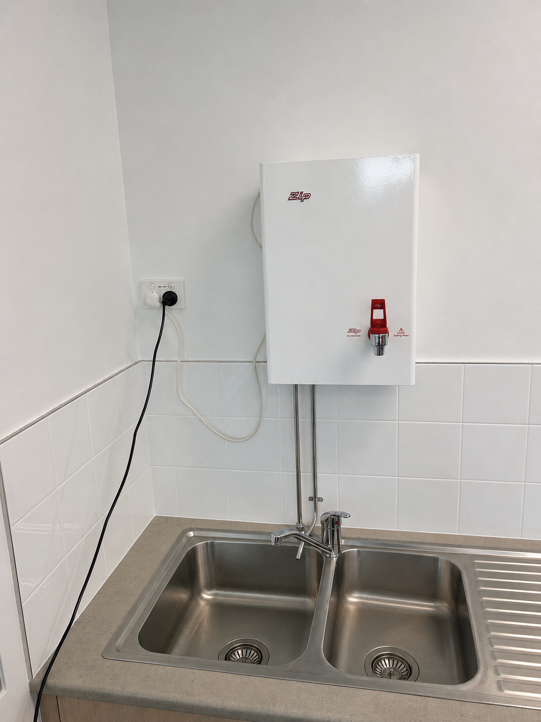 Small Utility Sink With Wall-mounted Water Heater — Huddo's Plumbing Service in Wallalong, NSW