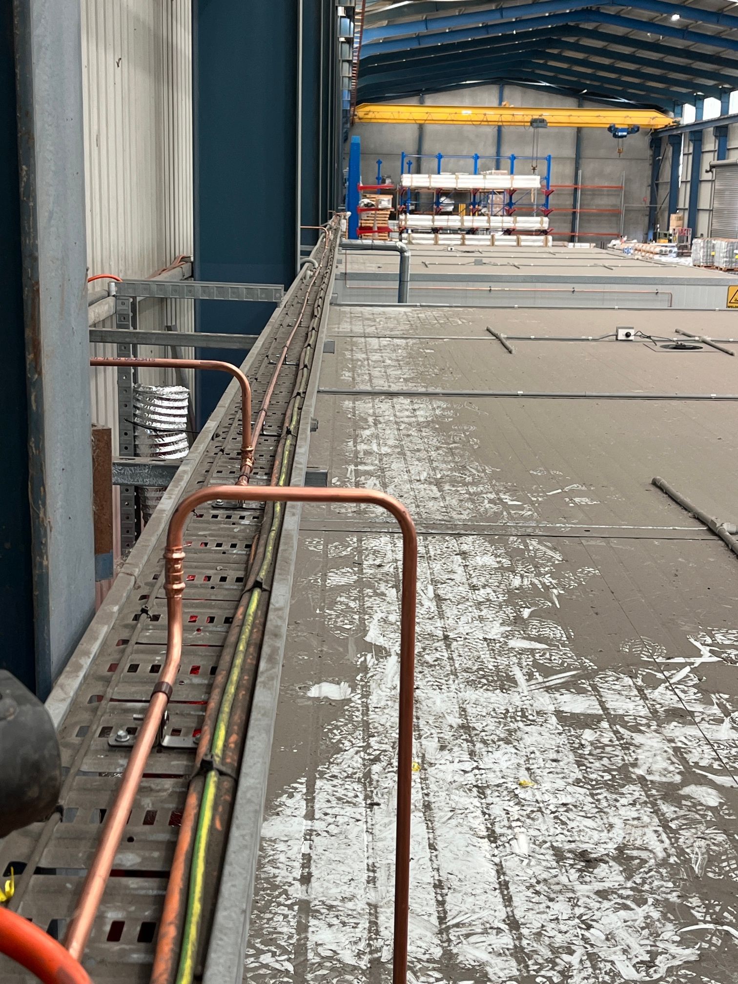 Industrial Walkway Inside a Warehouse With Pipes, Railings — Huddo's Plumbing Service in Wallalong, NSW