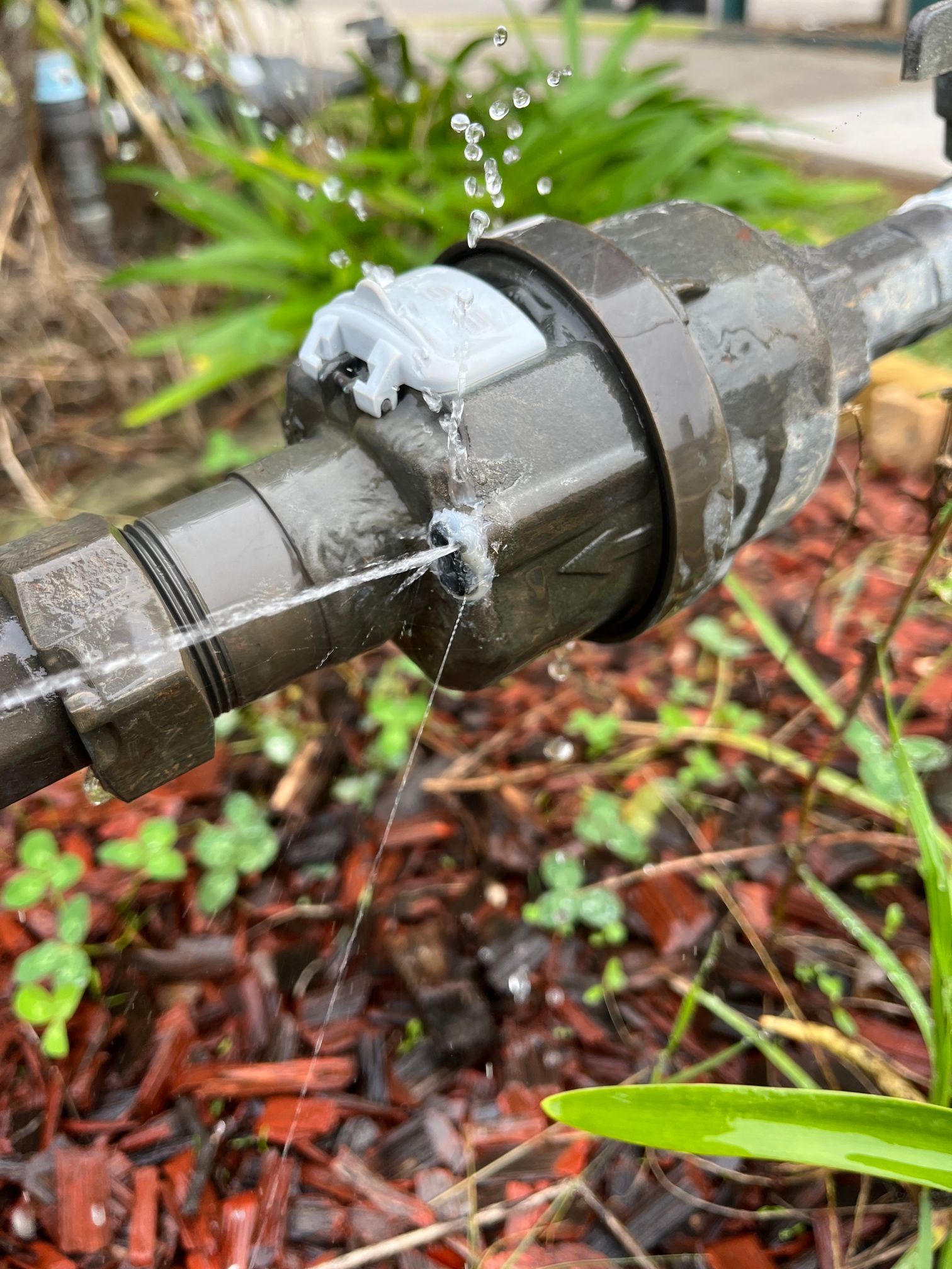 Cracked Pipe Leaking Water, Damaged Metal Pipe, Water is Flowing — Huddo's Plumbing Service in Wallalong, NSW