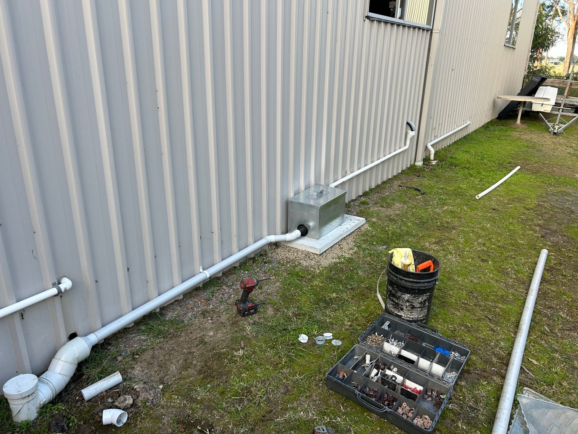 Outdoor Utility Area Beside A Metal Building — Huddo's Plumbing Service in Wallalong, NSW
