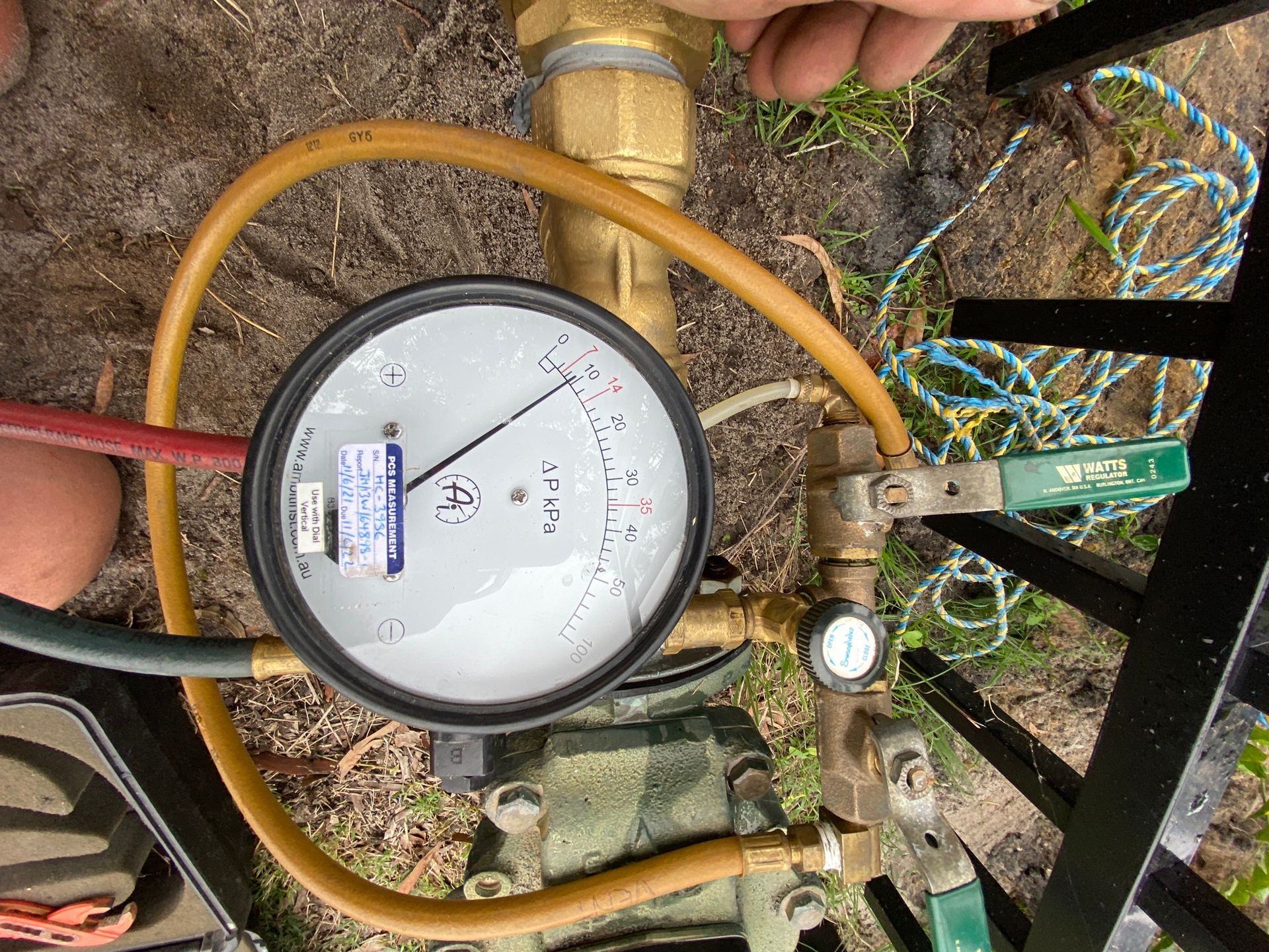 Close-up Of A Pressure Gauge And Hoses Connected — Huddo's Plumbing Service in Wallalong, NSW