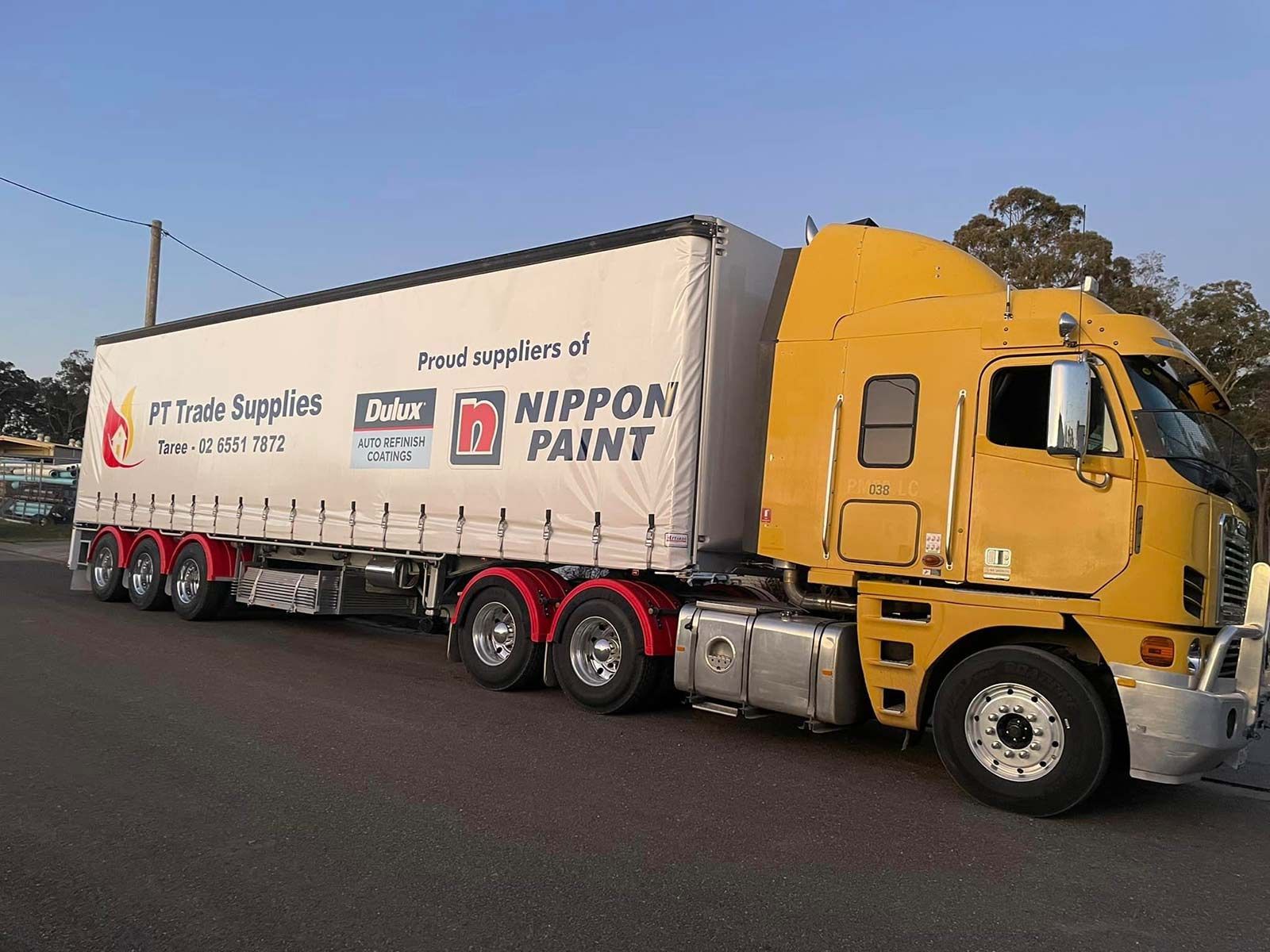 A Yellow Semi Truck With A Nippon Paint Trailer — PT Trade Supplies in Taree, NSW