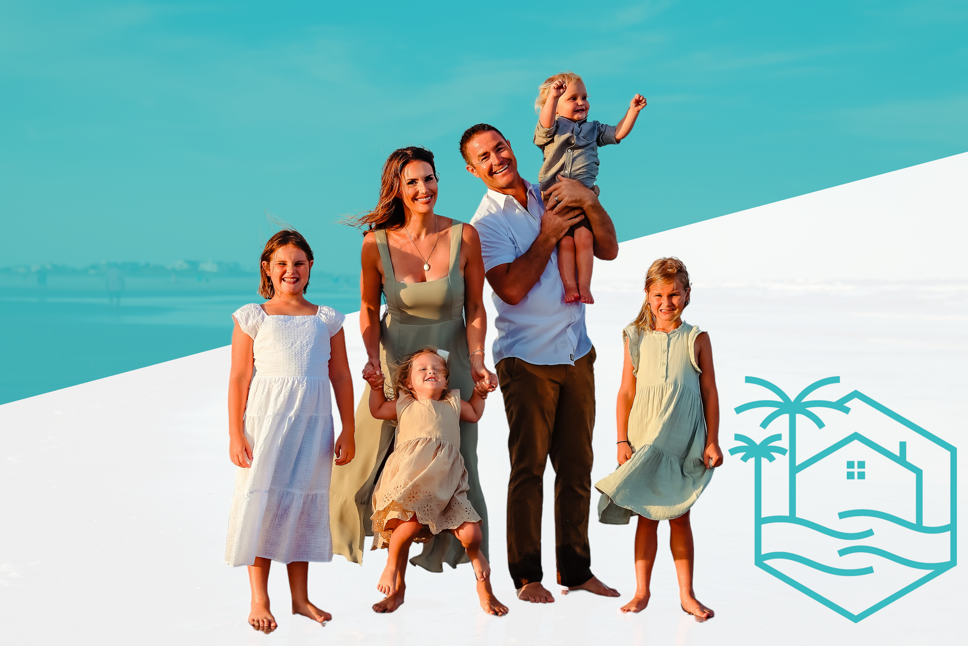 A family is posing for a picture on the beach
