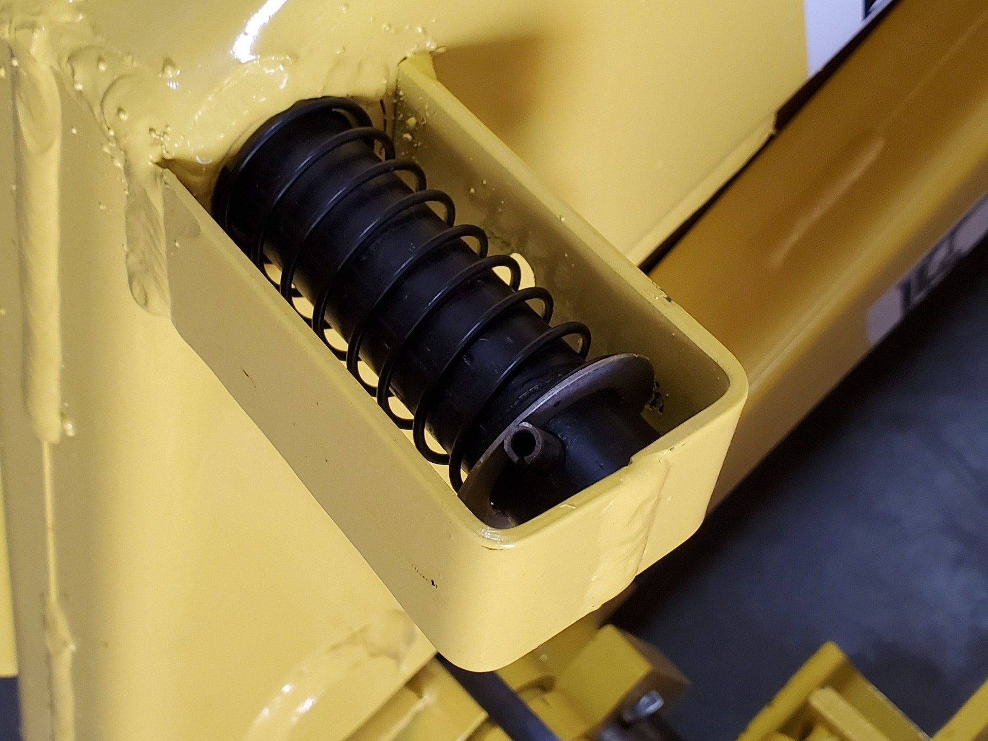 A yellow container with a black object inside of it