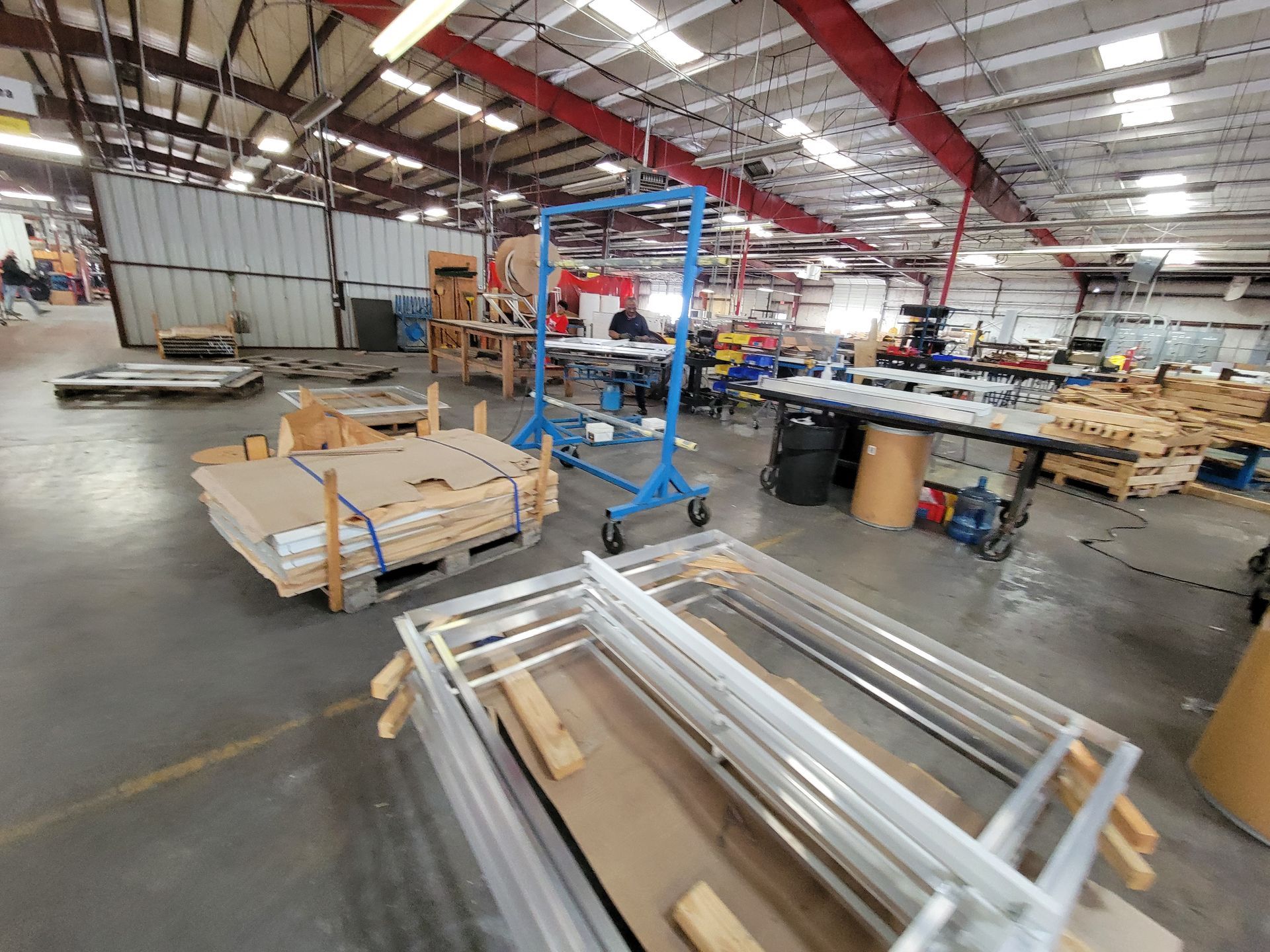 A warehouse filled with lots of boxes and pieces of metal.