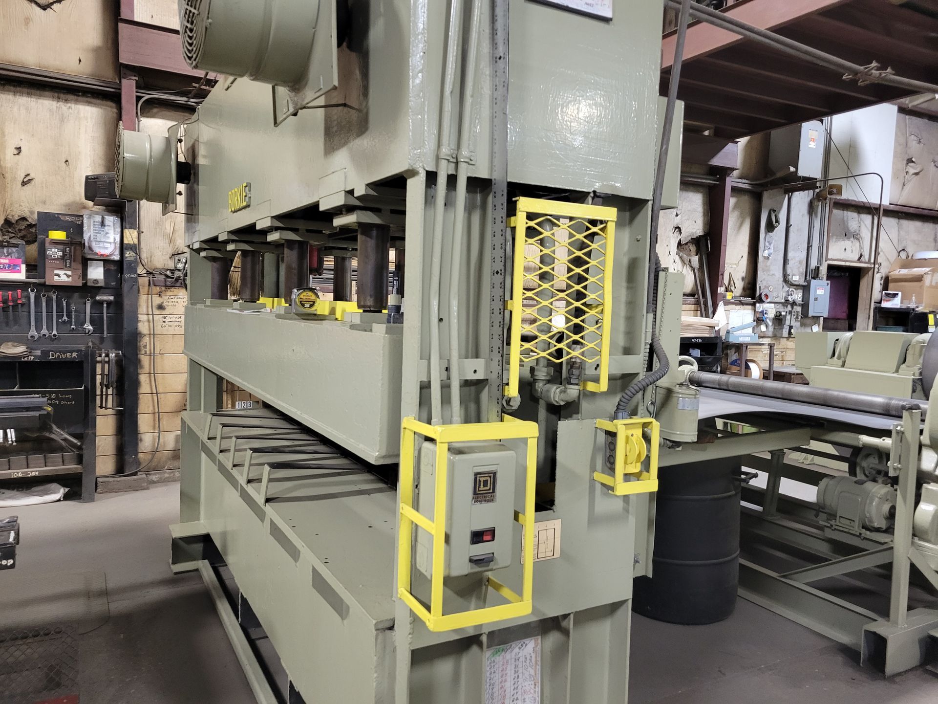 A large machine is sitting in a warehouse.