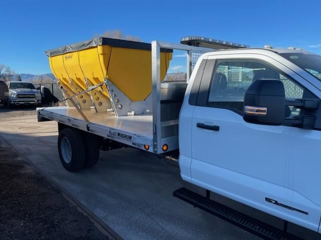 A white truck with a yellow box on the back of it