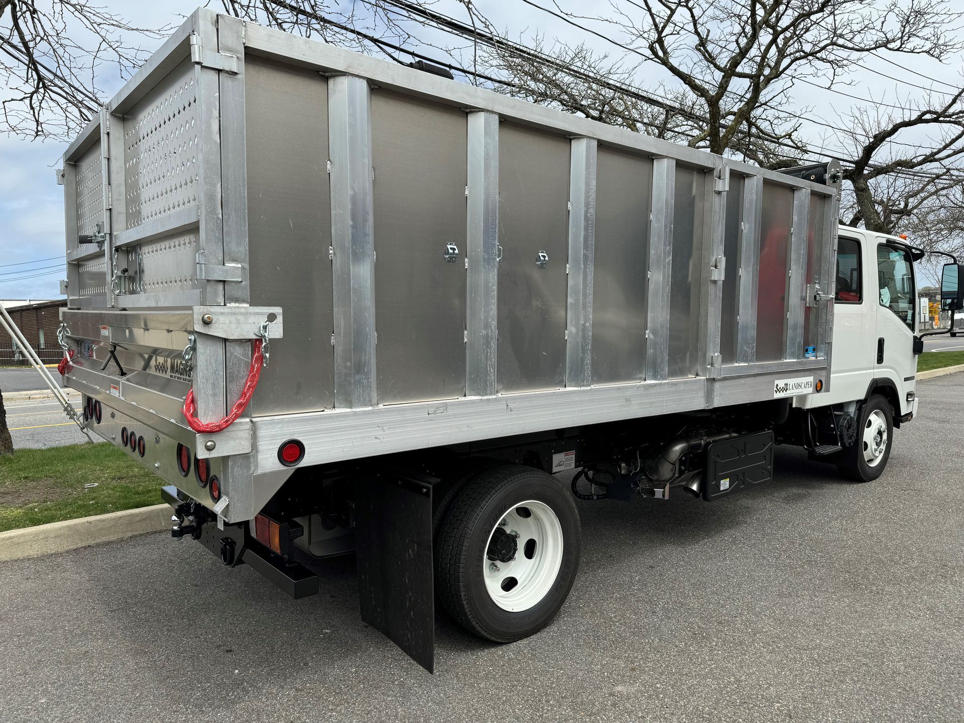 A dump truck is parked on the side of the road.