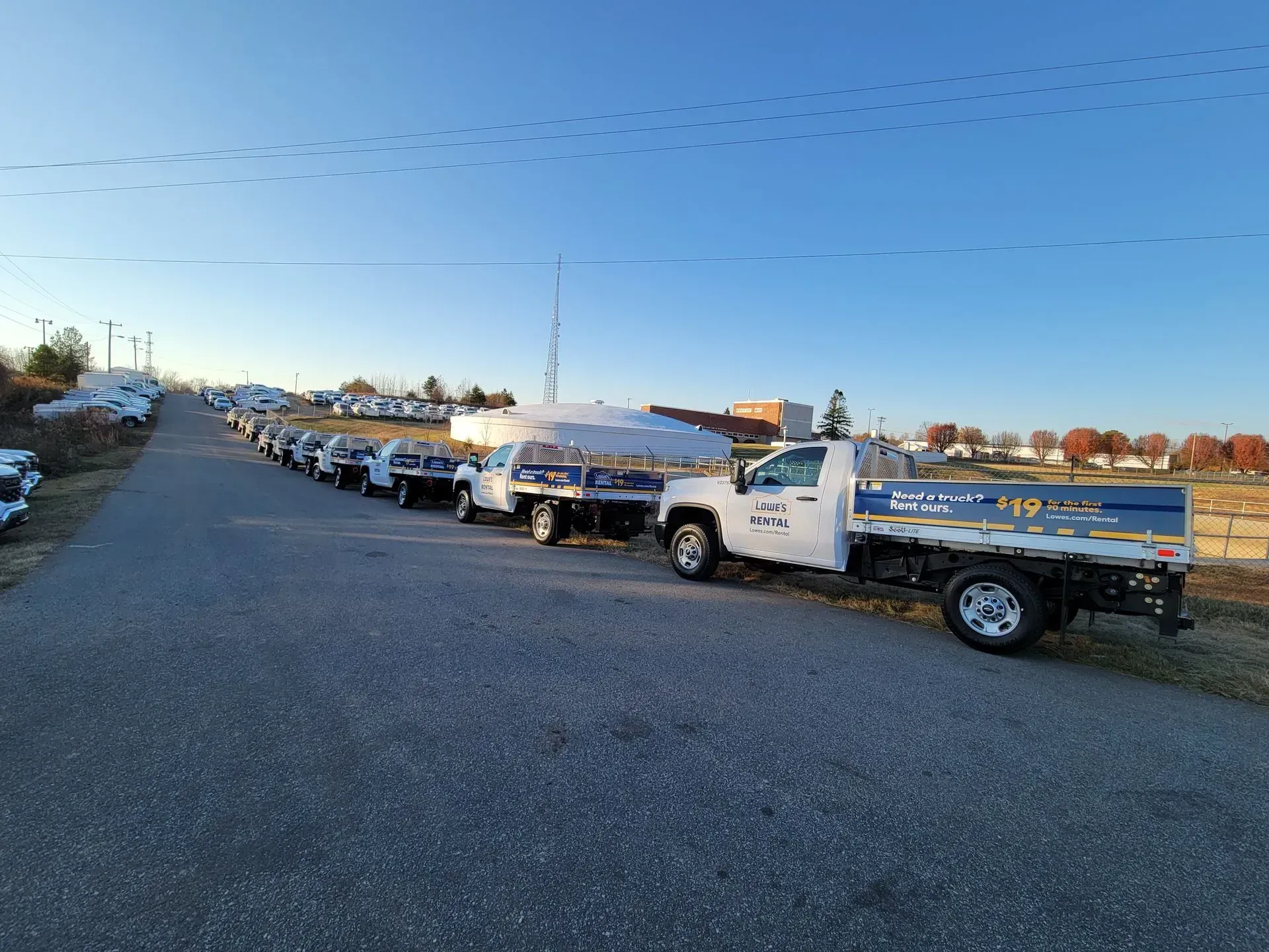 A row of trucks parked on the side of a road.
