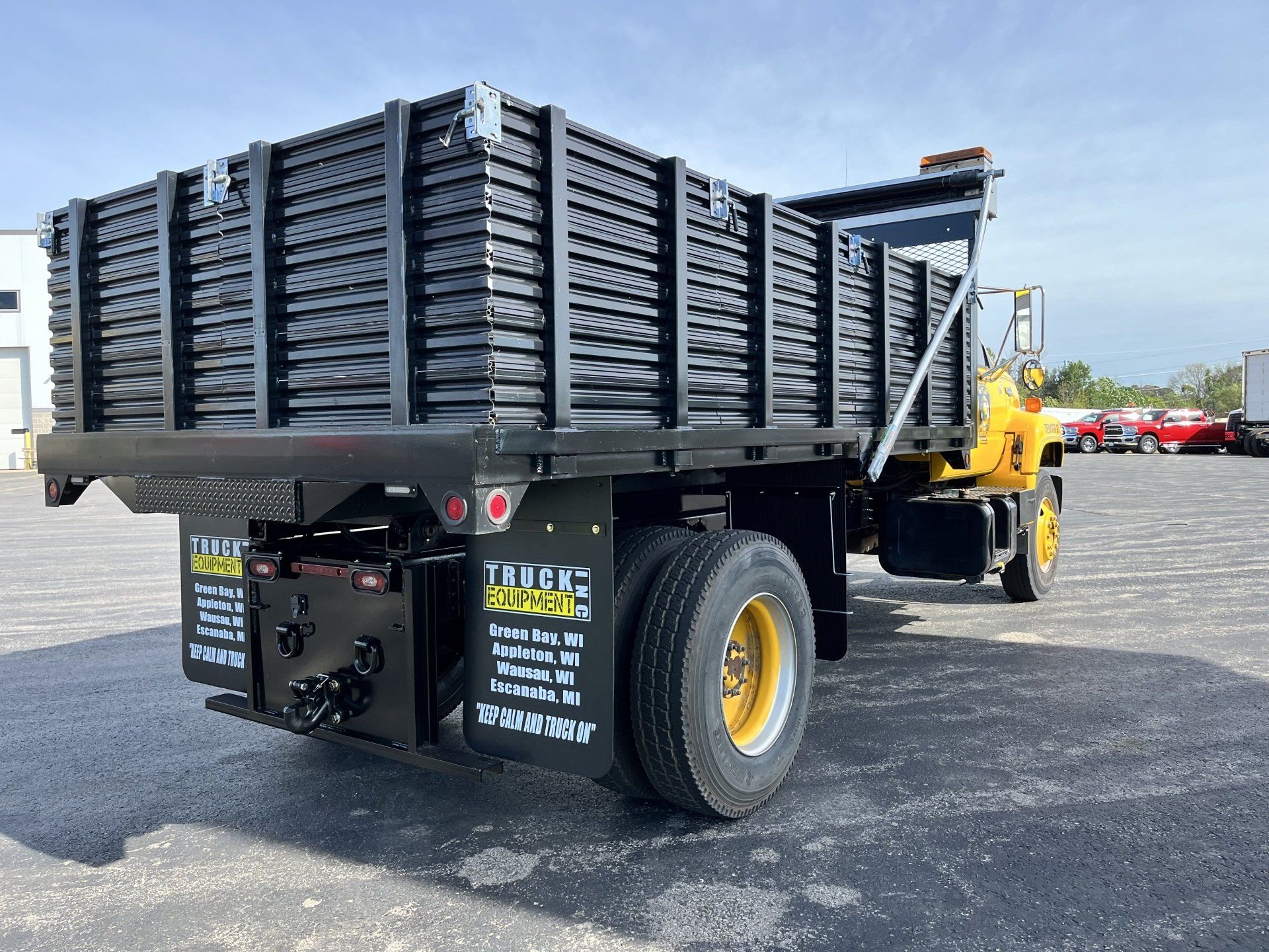 A dump truck is parked in a parking lot.