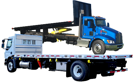 Tow truck carrying a blue dump truck and a white utility truck on a flatbed trailer