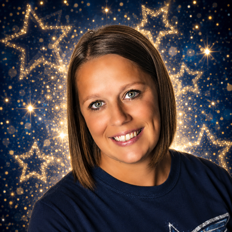 Smiling person in a navy shirt against a blue star-patterned background