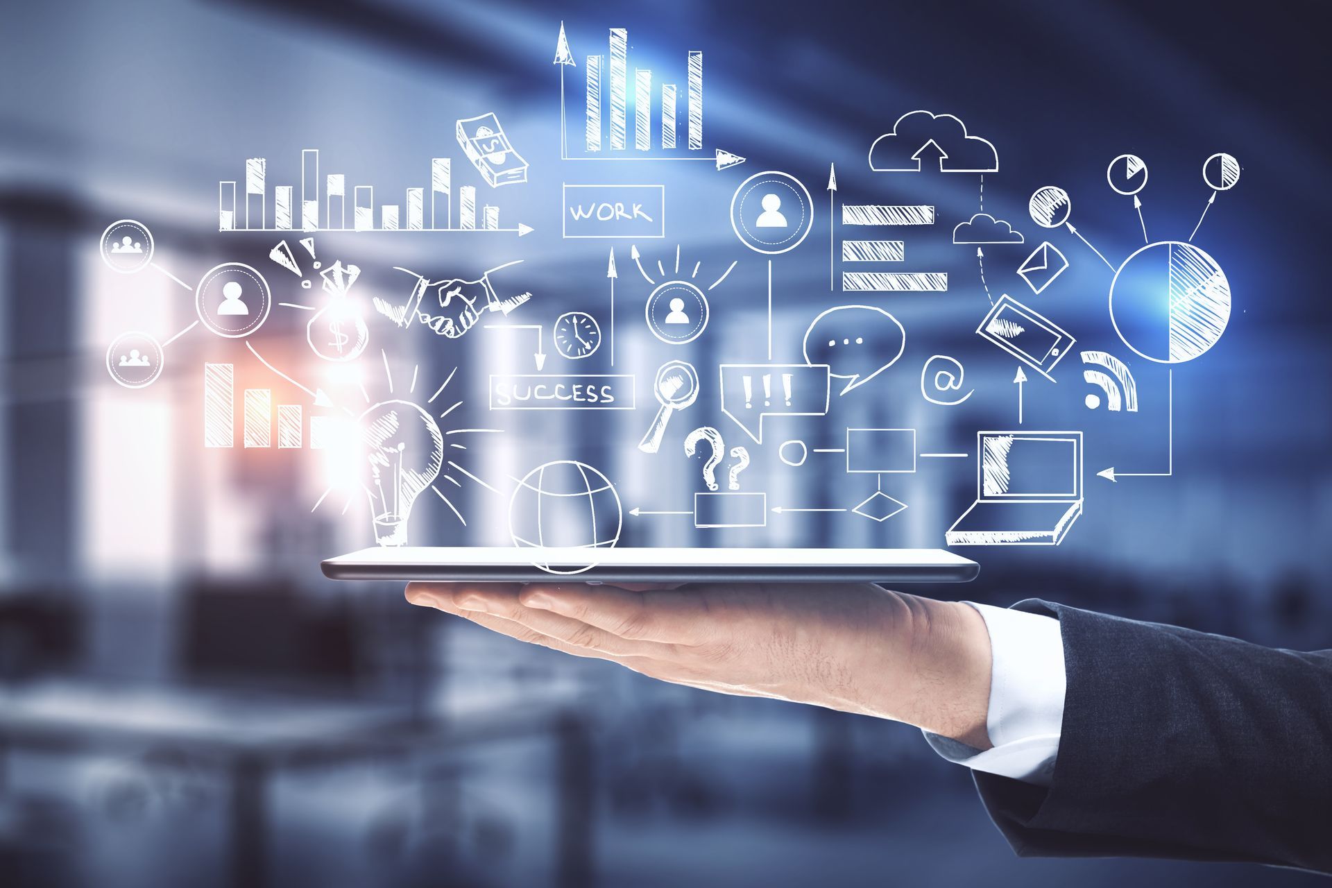Hand holding a glowing tablet with futuristic technology icons and data graphics hovering above it