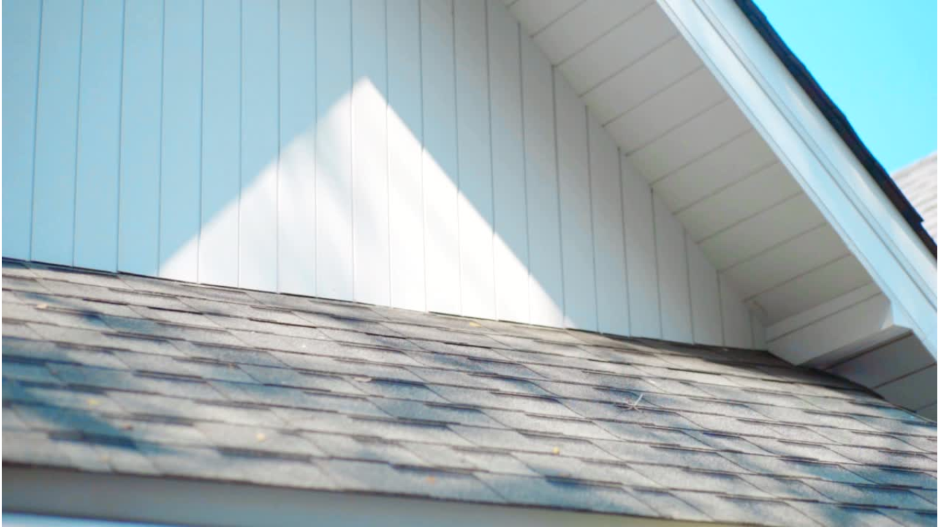 The roof of a house has a triangle shaped shadow on it