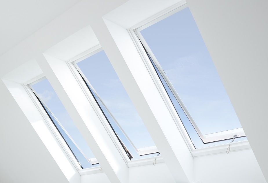 A row of skylights with a blue sky behind them