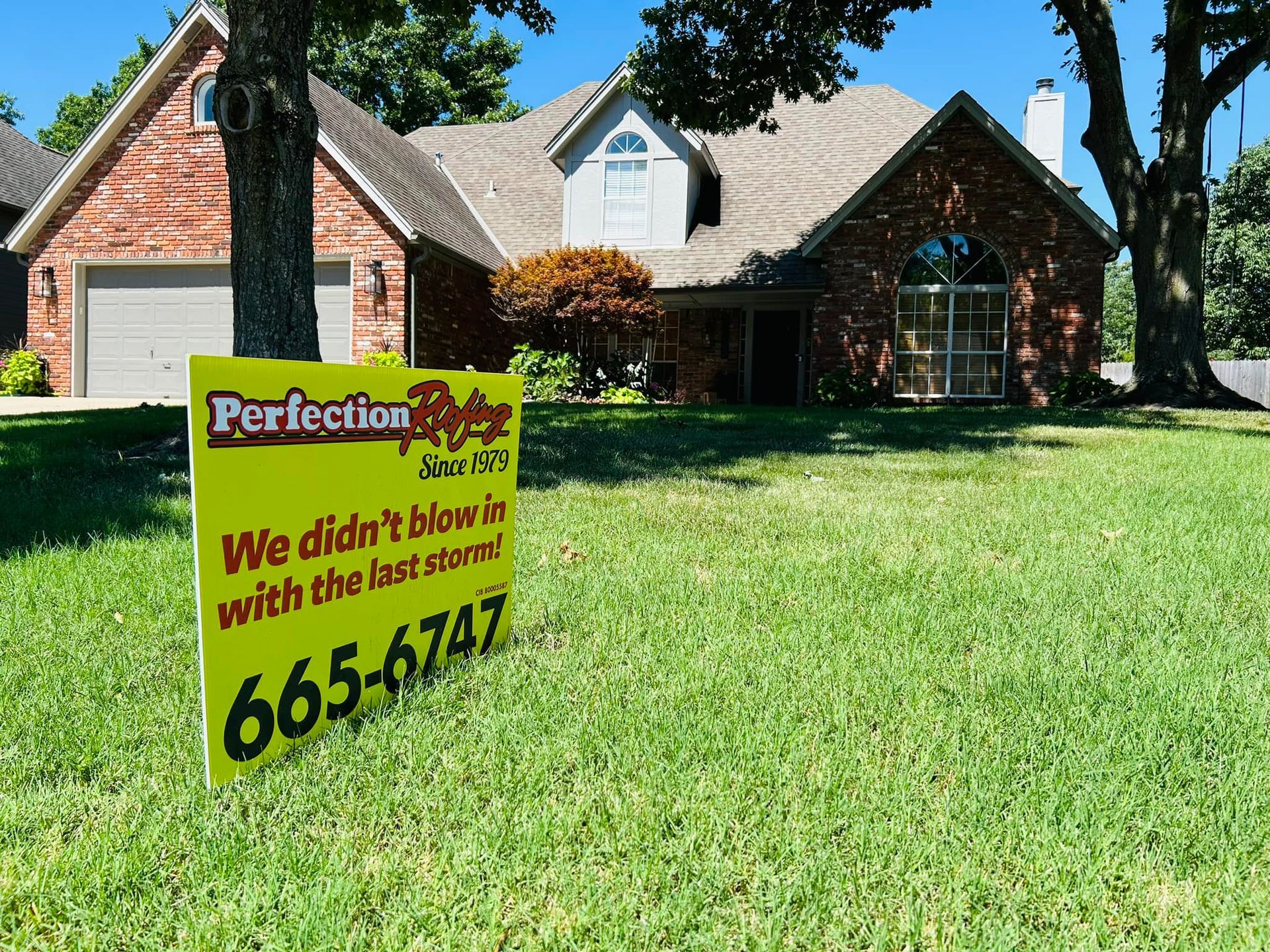 A house with a sign in front of it that says perfection