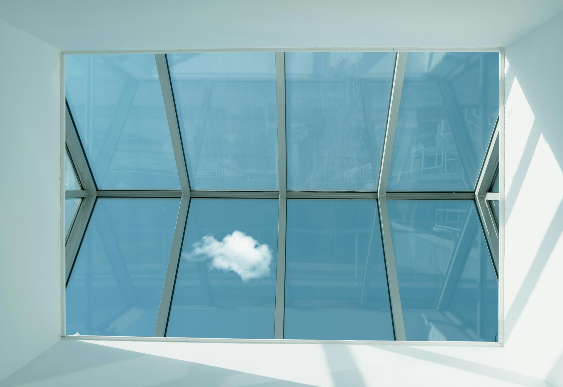 A cloud is visible through the skylight of a building.