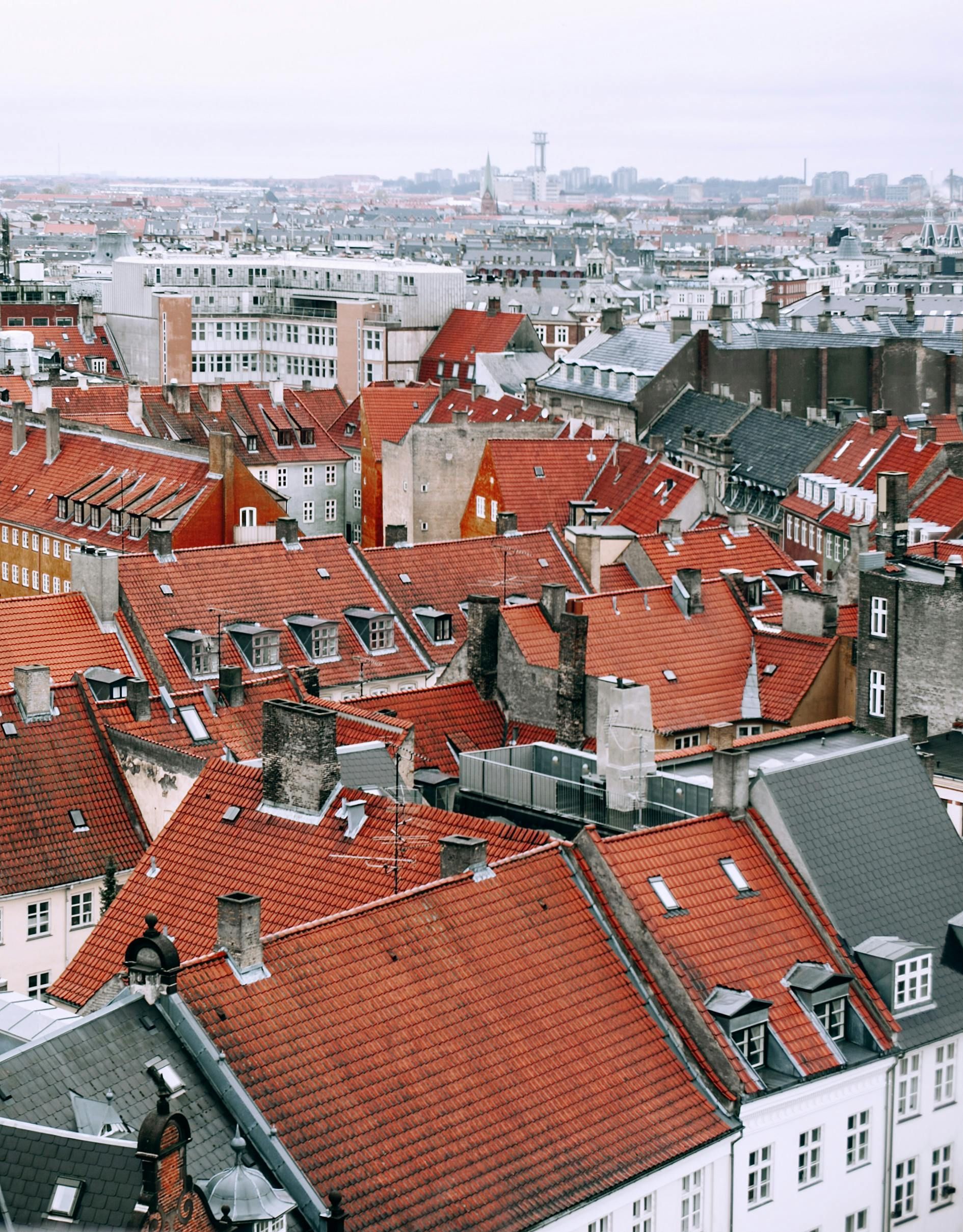 An aerial view of a city with red tiled roofs