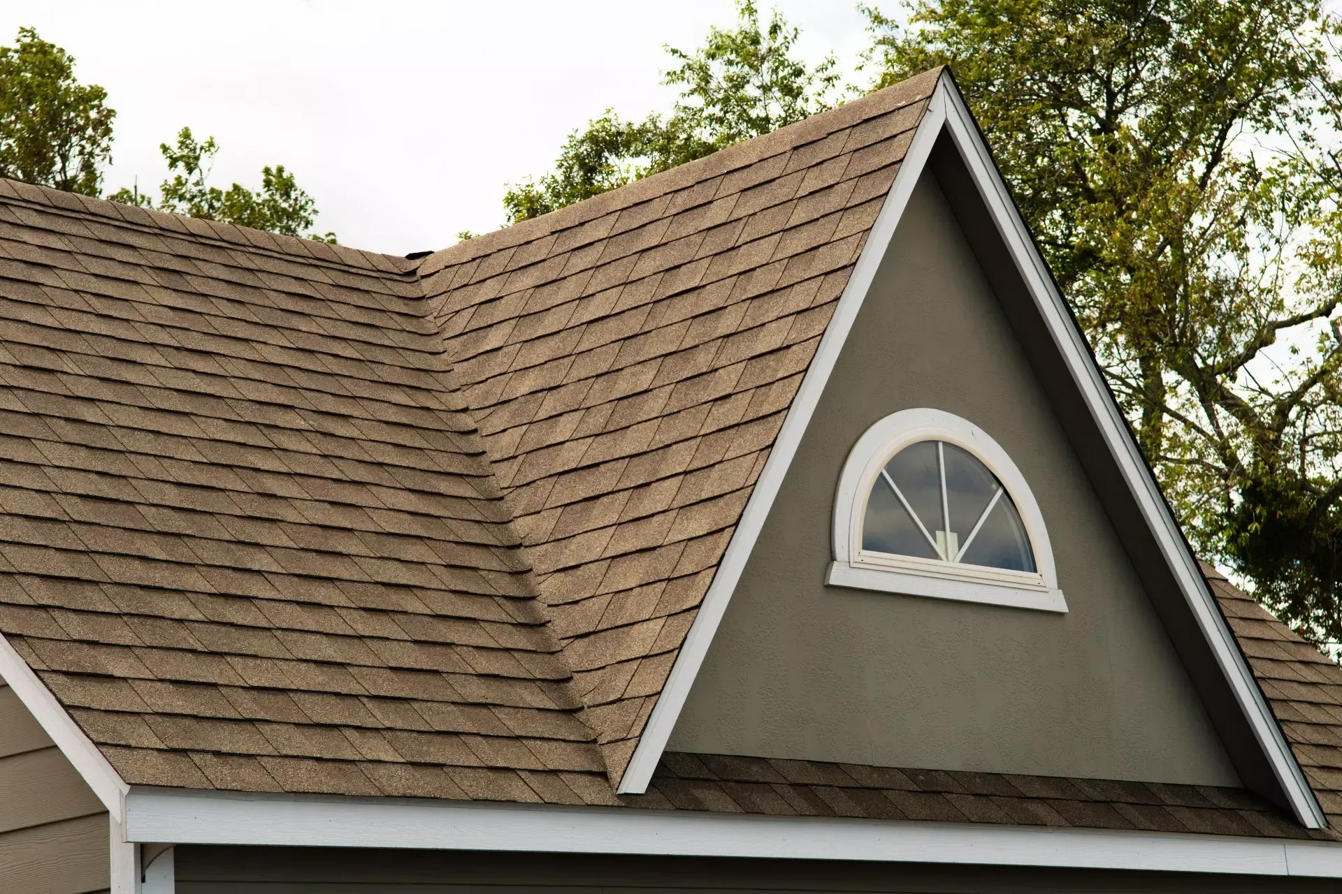 A house with a roof that has a window on it