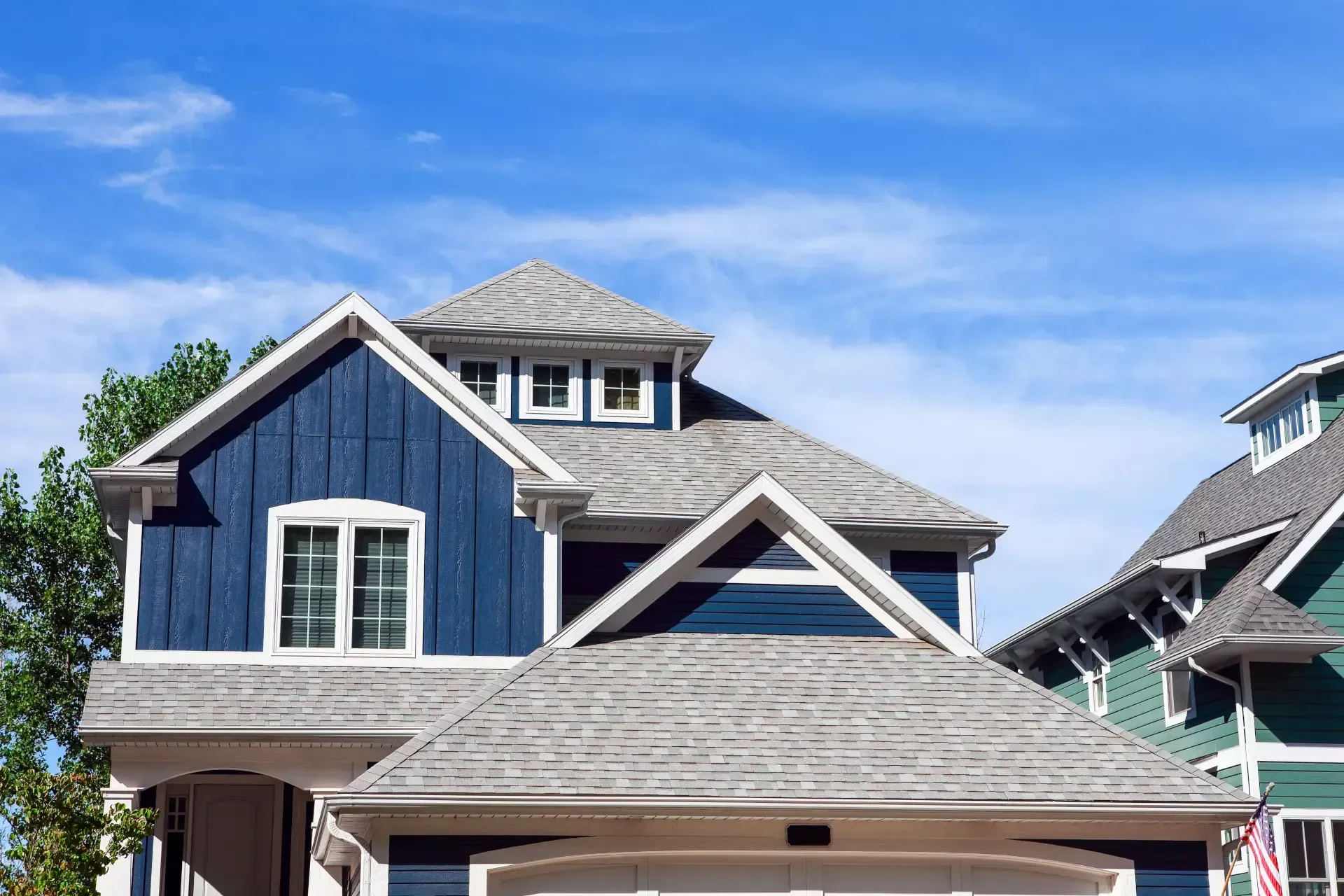 A blue and white house with a gray roof