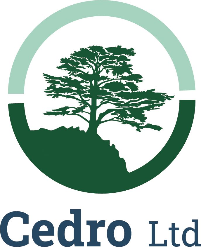 Logo: A green tree silhouette on a rocky outcrop within a two-toned green circle. The text