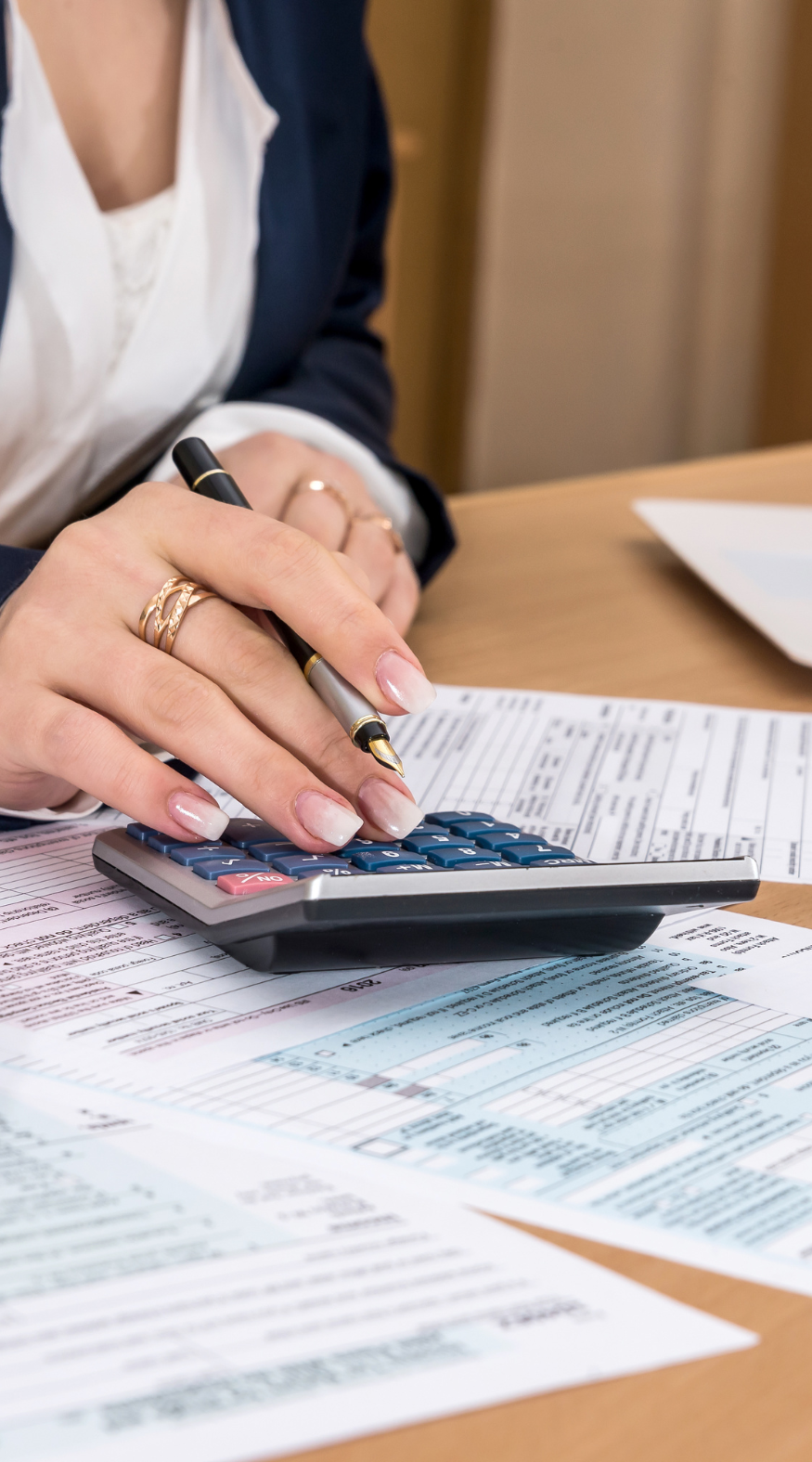Paperwork with a calculator being used on top of it