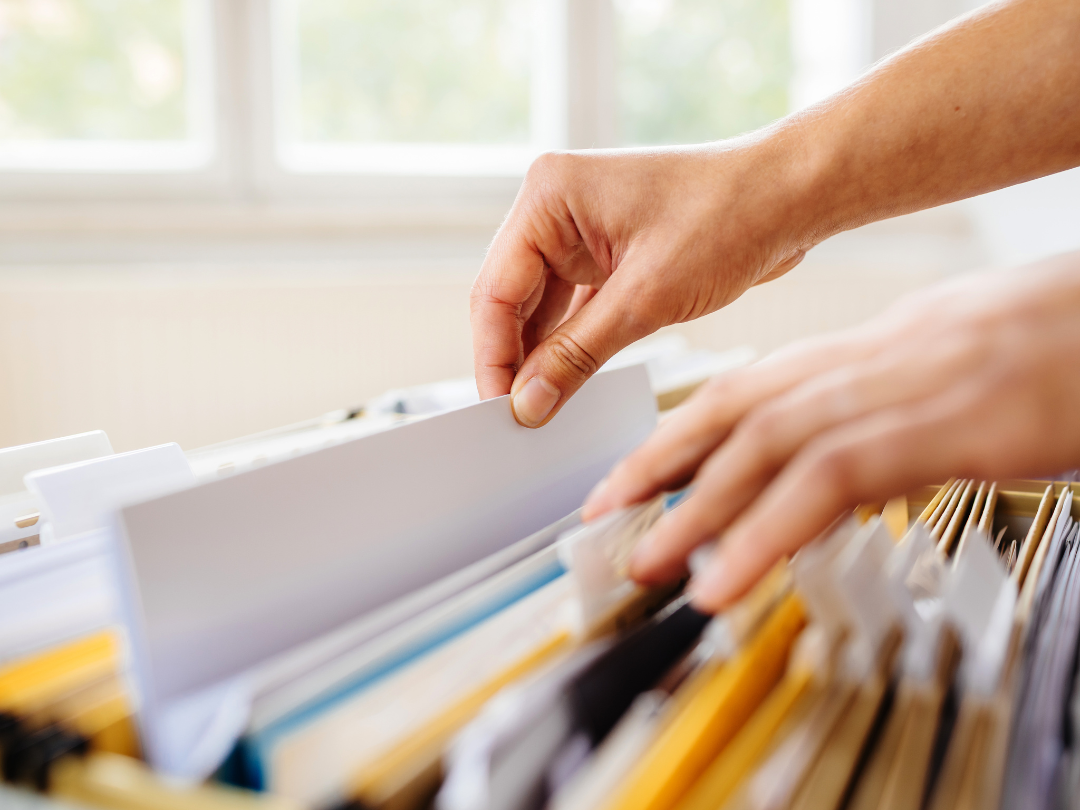 hands filing documents