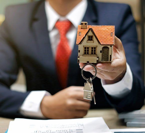 Lawyer Holding House With Keys — Albany, OR — The Law Office of Dustan E. Johnson Lawyer Holding House With Keys — Albany, OR — The Law Office of Dustan E. Johnson